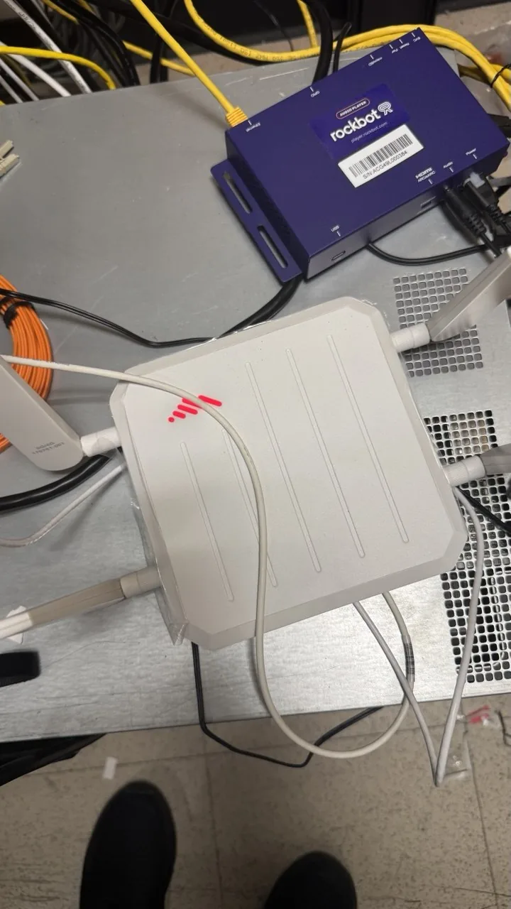 Cellular bridge device on a bench showing a red status light